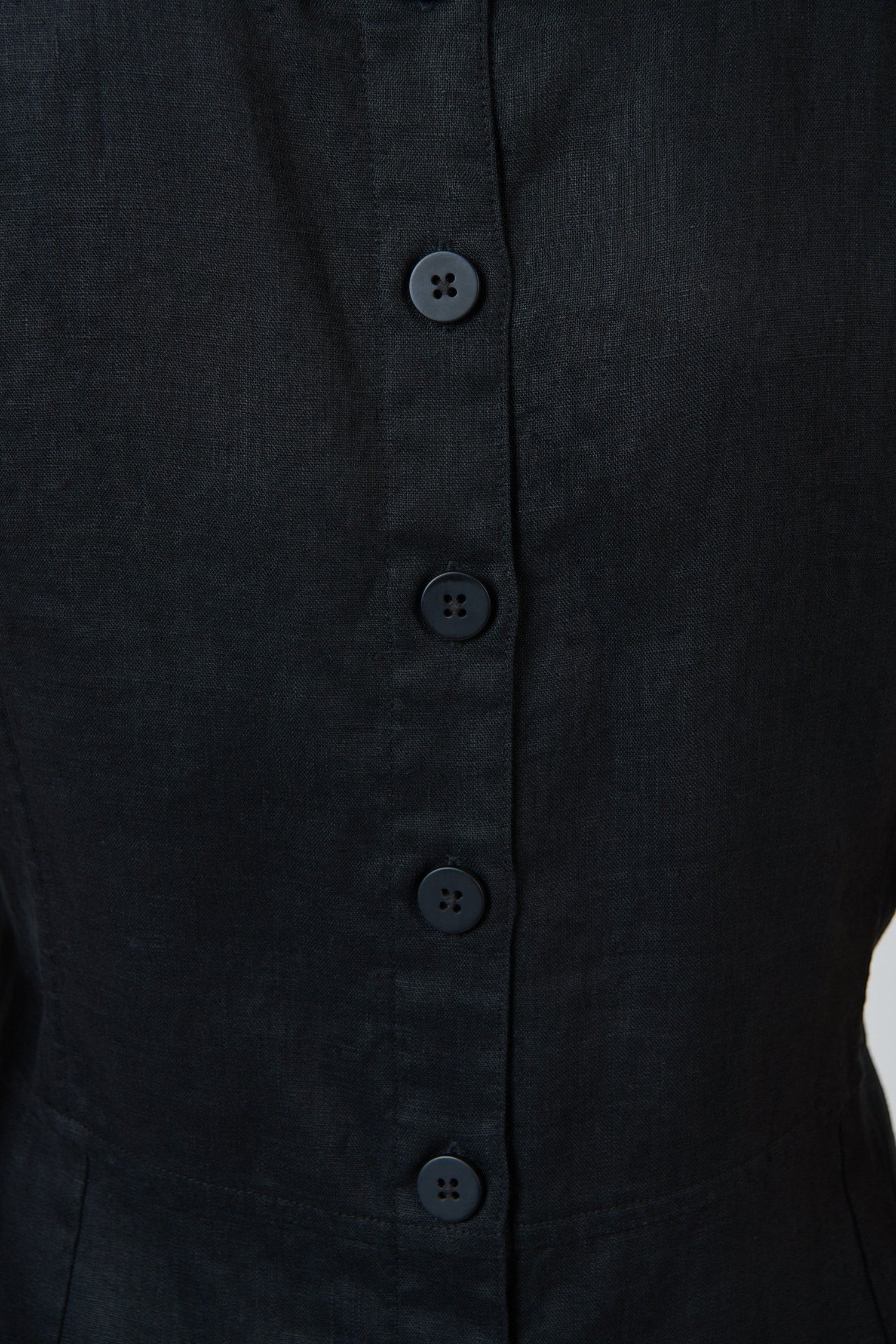 Close-up of the black linen fabric and tonal button placket on the back of an ELSHAM BOUTIQUE GA735 midi dress.