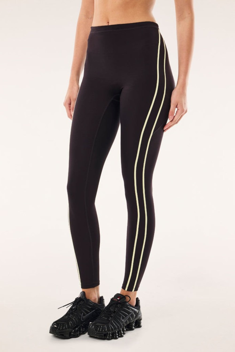 ELSHAM BOUTIQUE black bean high-rise leggings with soft yellow contrast flatlock side stripes and functional drawcord.