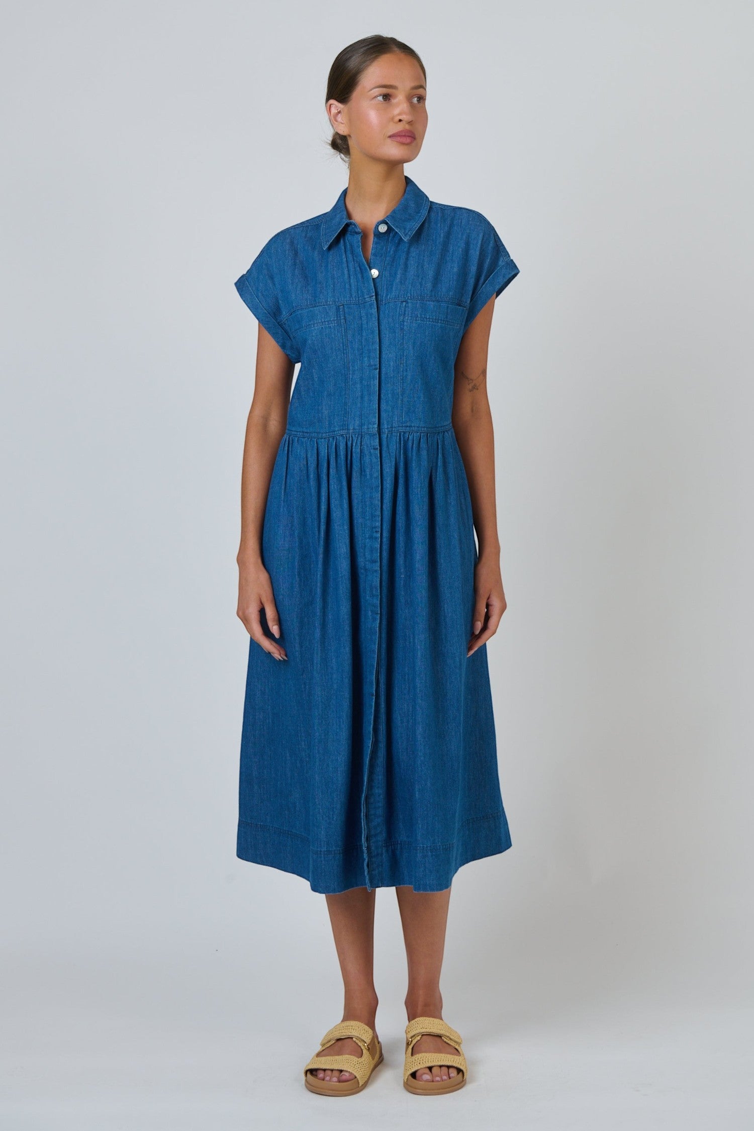ELSHAM BOUTIQUE chambray shirt dress with cap sleeves, gathered empire waist, and midi length A-line skirt.