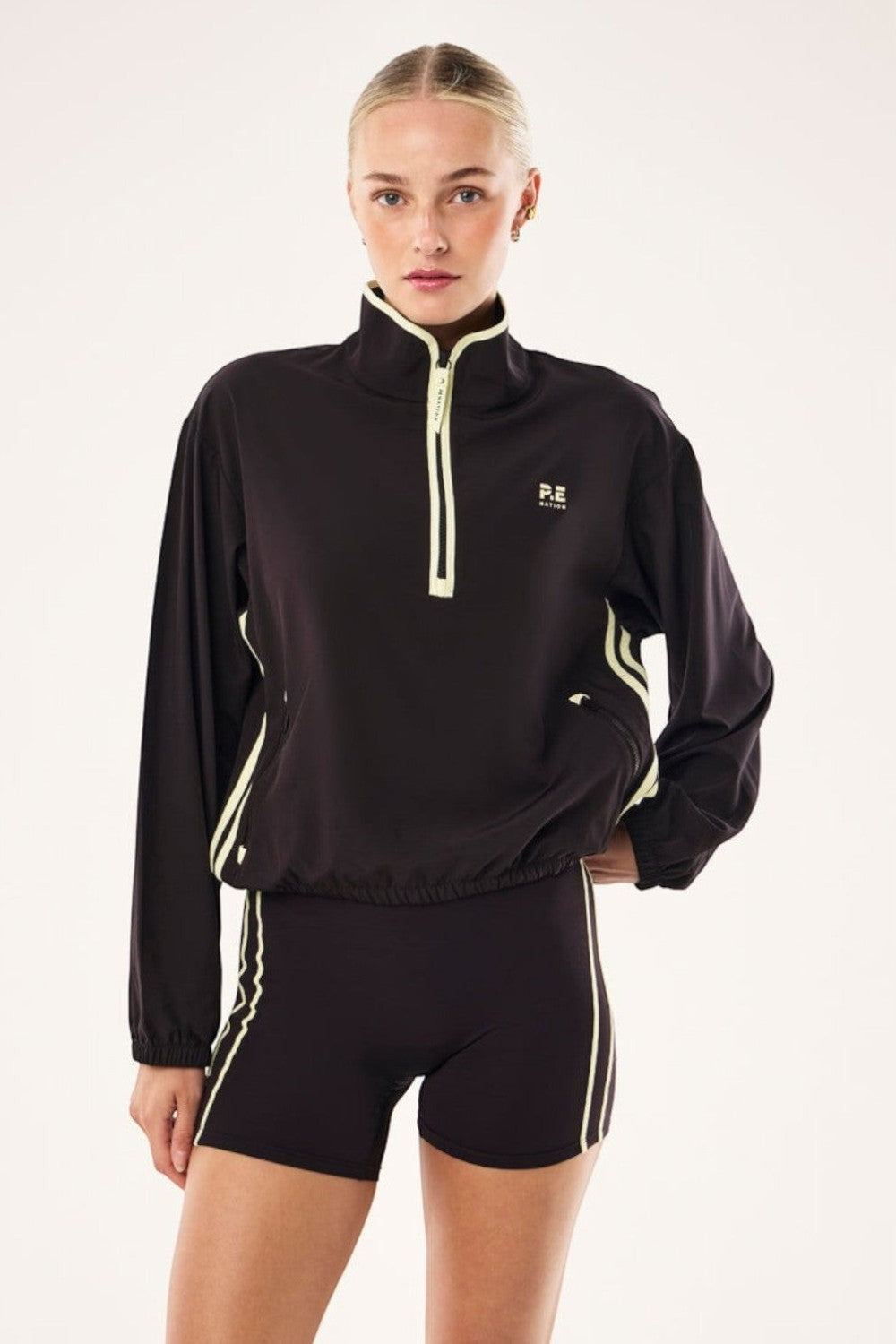 ELSHAM BOUTIQUE Echo black quarter zip jacket with contrast yellow binding, zipped pockets, and adjustable waist.