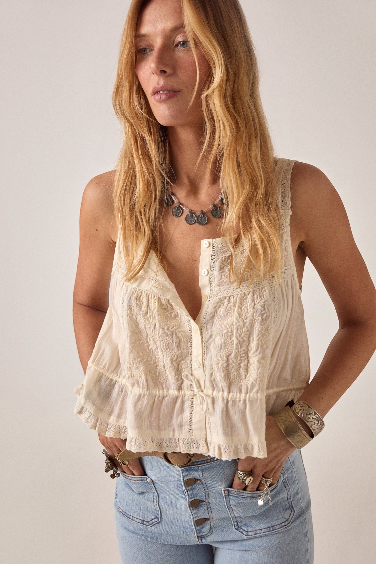 ELSHAM BOUTIQUE ivory cotton cropped top with delicate lace front panel, thin straps, and drawstring waist detail.