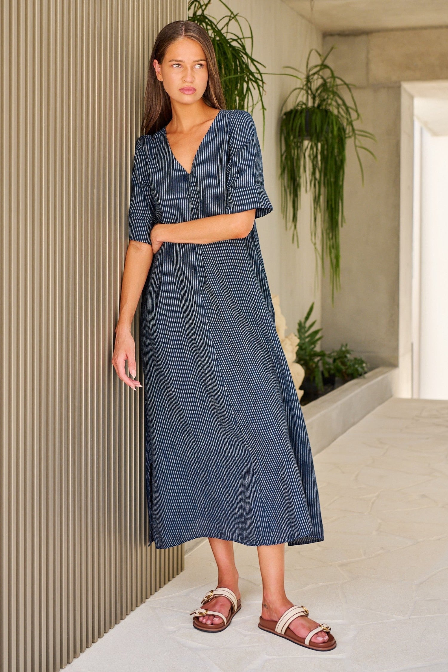 ELSHAM BOUTIQUE navy pinstripe linen A-line midi dress with V-neck and elbow-length sleeves worn by a model