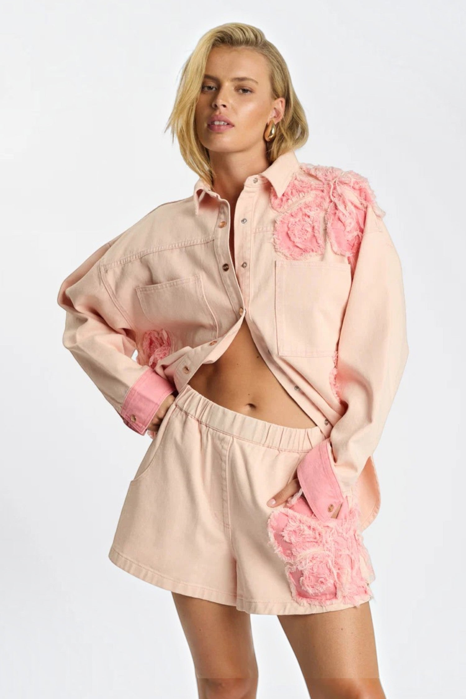 ELSHAM BOUTIQUE model wearing pink petal high-waisted elasticated denim shorts with matching embroidered denim shirt