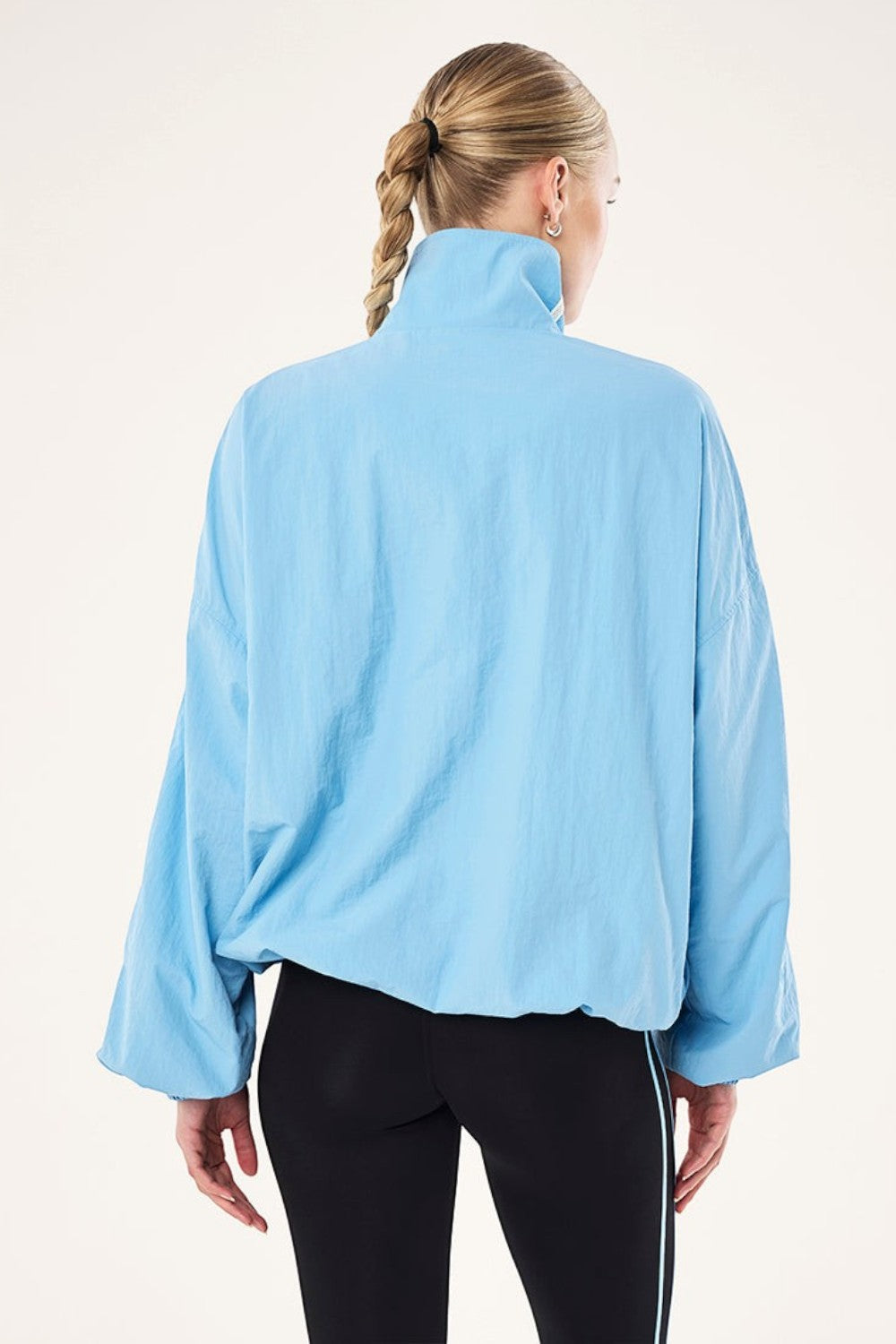 ELSHAM BOUTIQUE Alaskan Blue Radius Jacket with funnel neck, oversized fit, and adjustable hem drawcord, back view.
