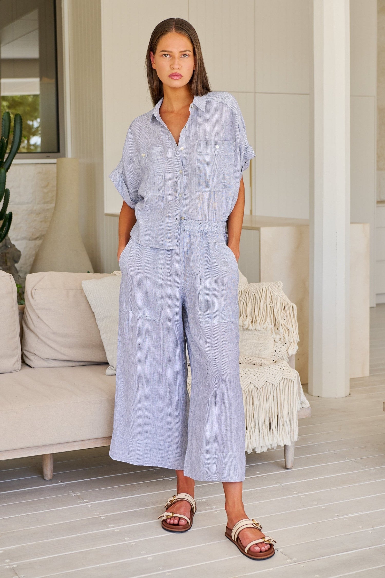 Model wearing ELSHAM BOUTIQUE silver linen wide-leg cropped pants with an elastic waistband and oversized pockets.
