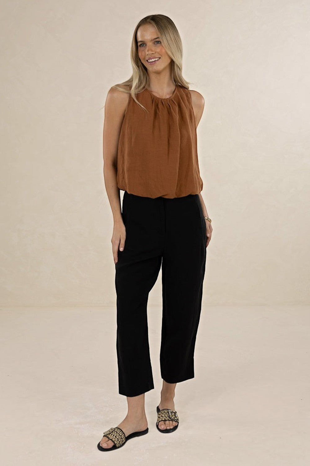 Model wearing ELSHAM BOUTIQUE tobacco linen-tencel sleeveless Samara Top with gathered neckline and elasticated hem