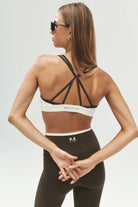 ELSHAM BOUTIQUE Activate sports bra in coffee and white with double twisted back straps worn by a model