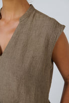 ELSHAM BOUTIQUE agate linen midi dress featuring a V-neckline and cap sleeves in a close-up view