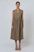 ELSHAM BOUTIQUE agate linen midi dress with V-neckline, cap sleeves, and gathered drop waist on a model