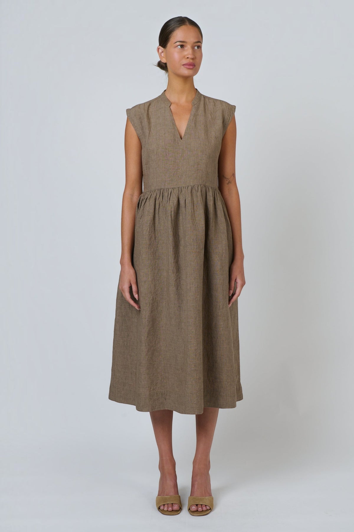 ELSHAM BOUTIQUE agate linen midi dress with V-neck, cap sleeves, and gathered drop waist on a model