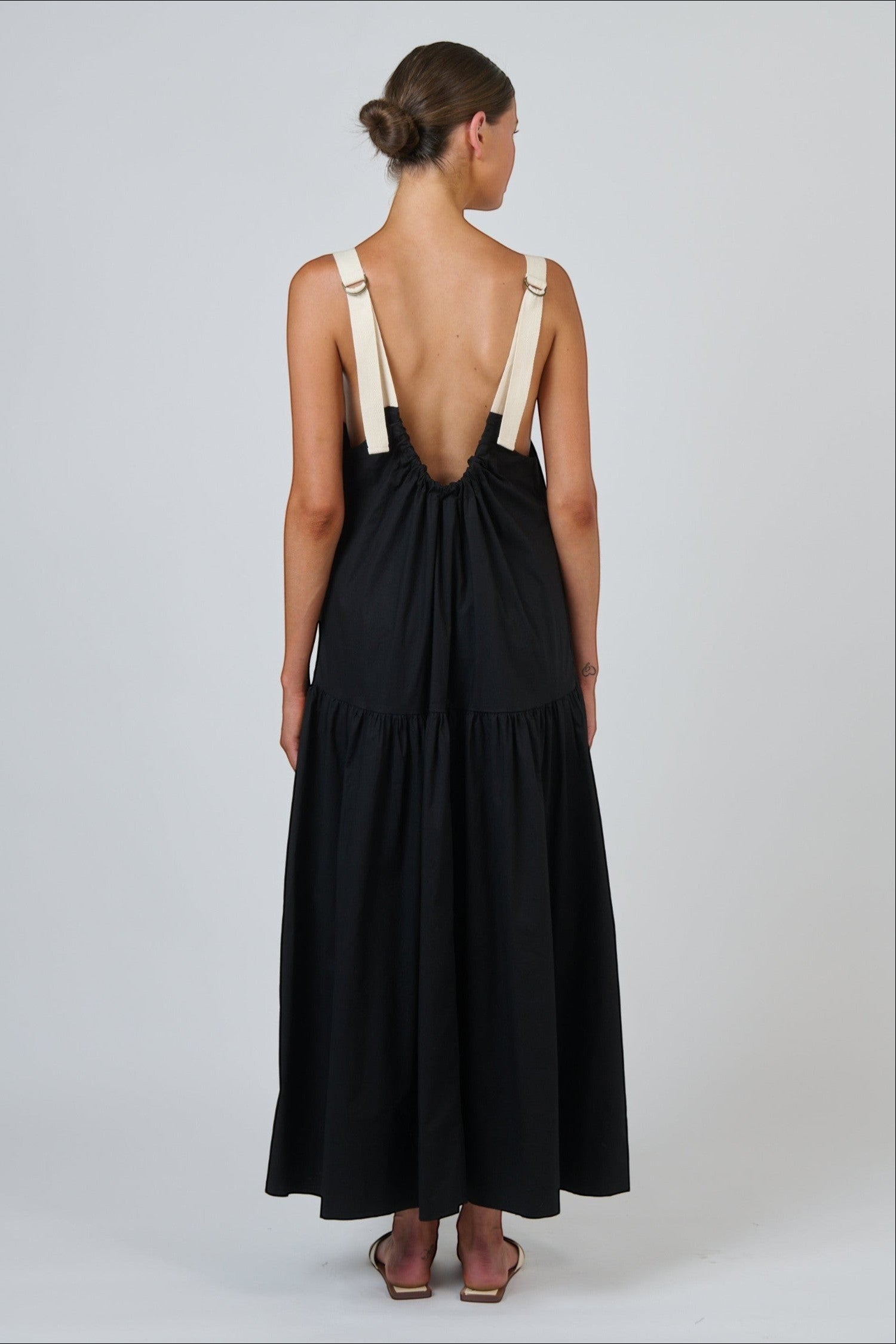 ELSHAM BOUTIQUE black poplin maxi dress with contrast buckle straps and a scoop back, shown from the rear view.