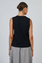 Back view of ELSHAM BOUTIQUE black cotton sleeveless muscle top with a round neckline on a model