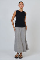 ELSHAM BOUTIQUE black cotton sleeveless muscle top with a round neckline worn by a model with a grey maxi skirt
