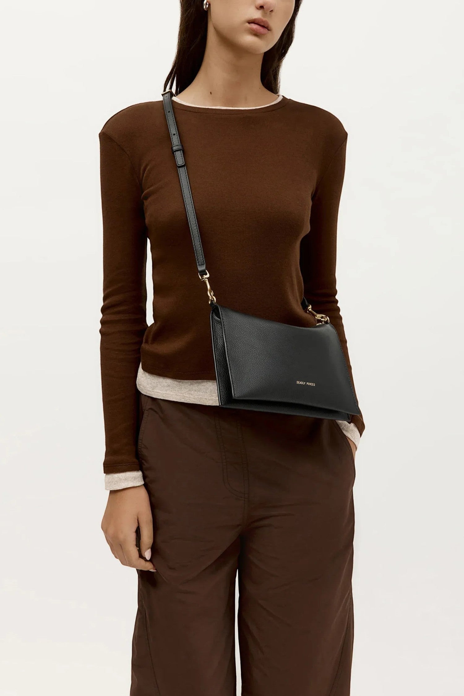 ELSHAM BOUTIQUE black calf nappa leather Siamese bag worn as a crossbody with gold hardware and adjustable strap
