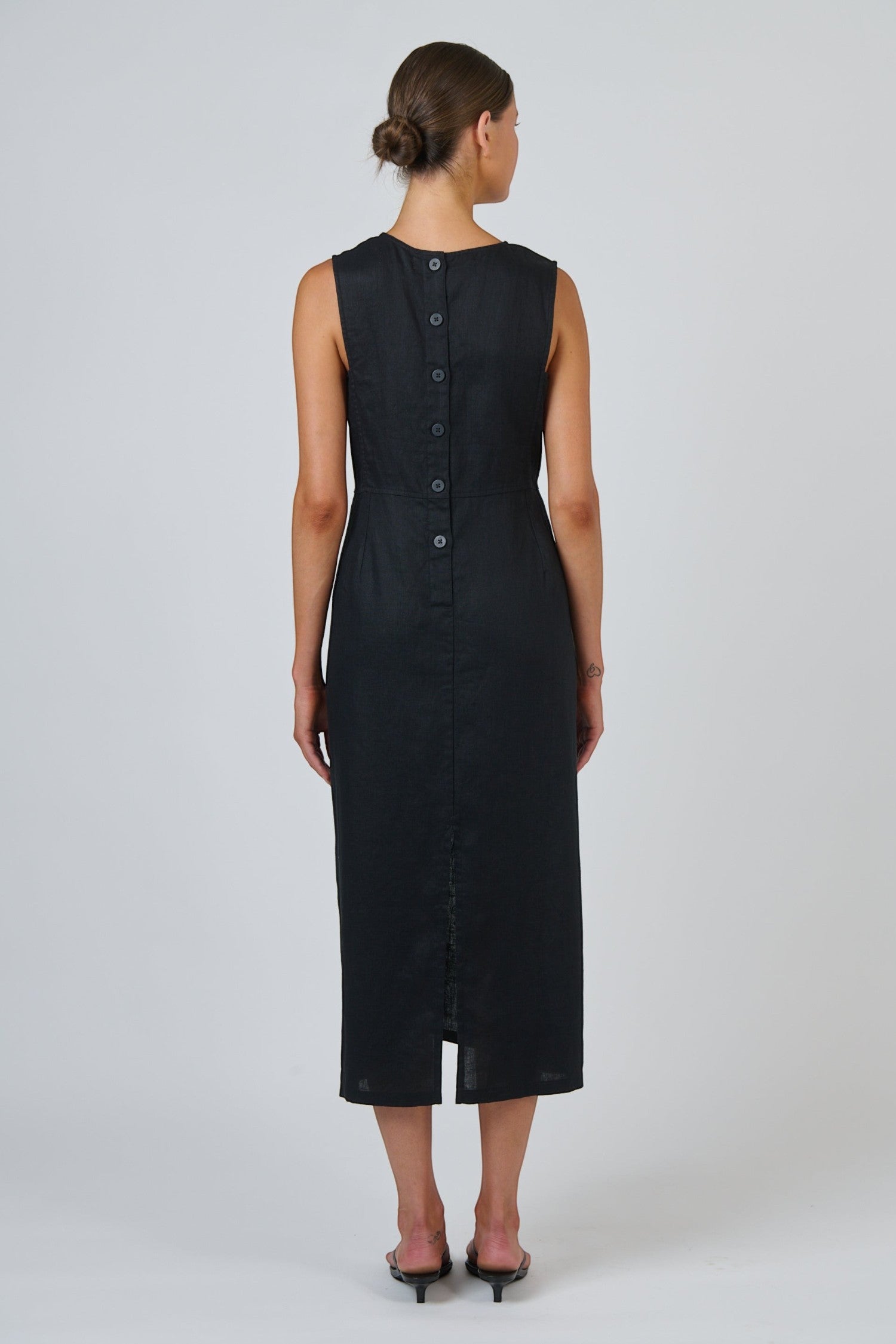 ELSHAM BOUTIQUE black linen midi dress with a sleeveless fitted bodice and a tonal button placket back view