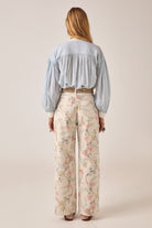 ELSHAM BOUTIQUE Bonifacio shirt in light blue pinstripe cotton with balloon sleeves worn with floral print trousers