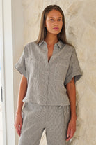 Model wearing ELSHAM BOUTIQUE GA723 boxy linen shirt in grey pinstripe with cuffed sleeves and patch pockets.