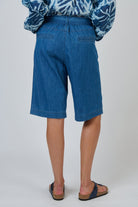 ELSHAM BOUTIQUE chambray denim Bermuda shorts with a high waist, self-tie belt, and back welt pockets, rear view.