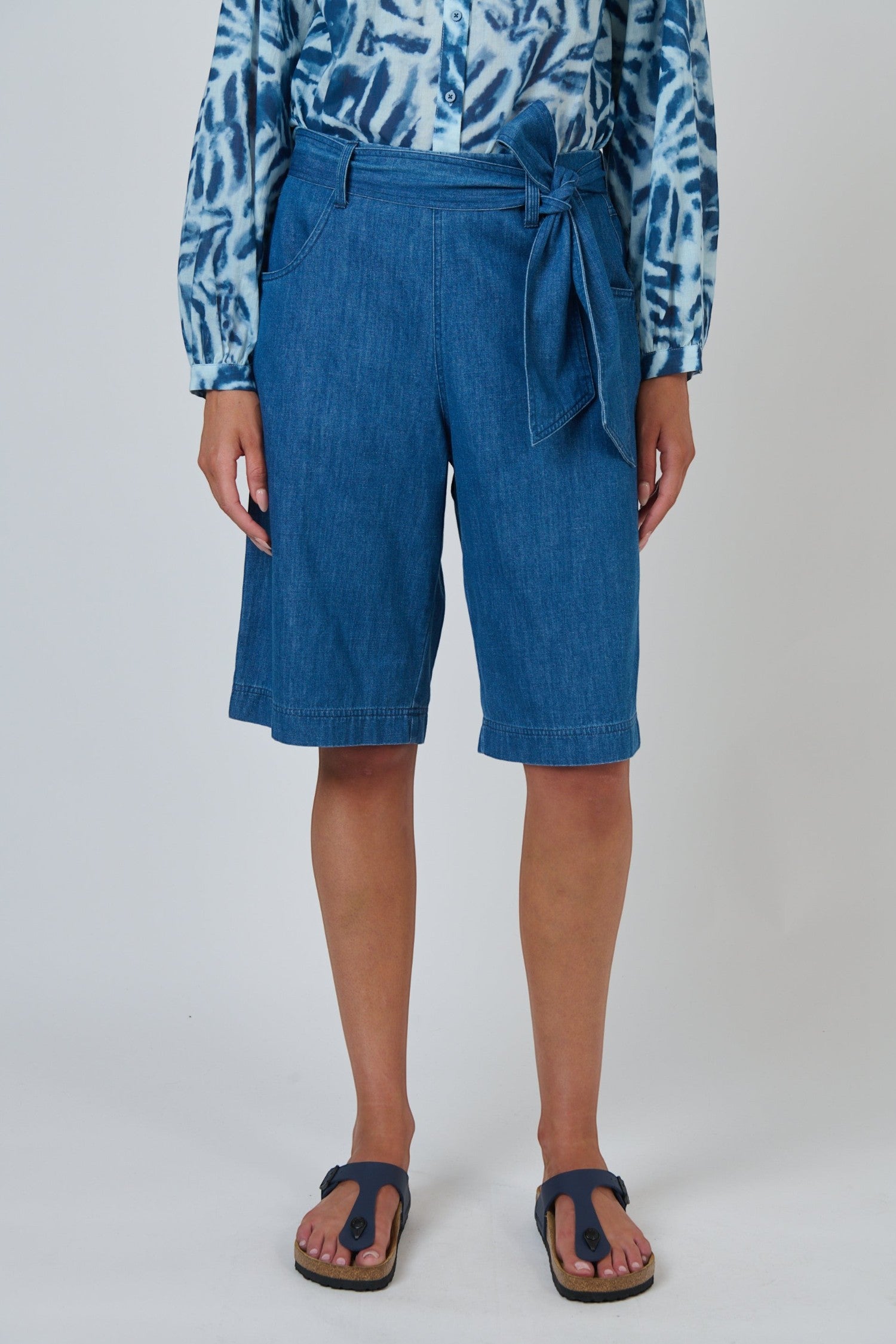 ELSHAM BOUTIQUE high-waisted chambray denim Bermuda shorts with a self-tie belt and wide-leg fit.