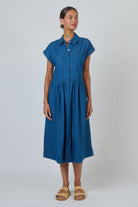 ELSHAM BOUTIQUE chambray shirt dress with cap sleeves, gathered empire waist, and midi length A-line skirt.