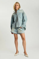 ELSHAM BOUTIQUE model wearing folklore chambray blue denim shorts and matching embroidered shirt with high waist fit.