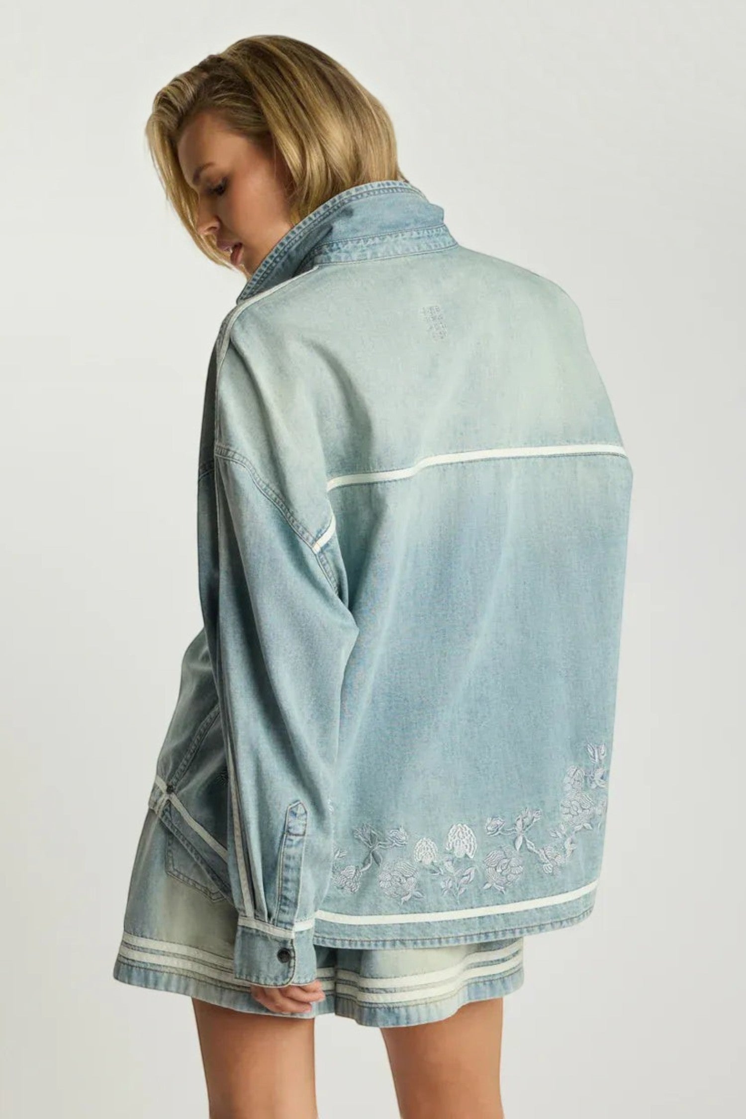 ELSHAM BOUTIQUE chambray blue denim shirt with delicate white embroidery and relaxed fit worn by a blonde model