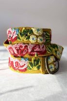 ELSHAM BOUTIQUE Giverny mustard yellow wool belt featuring vibrant floral embroidery and a lead-free metal buckle.