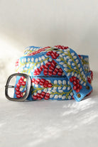 ELSHAM BOUTIQUE wool belt in light blue with red and white berry vine embroidery and a lead-free metal buckle.
