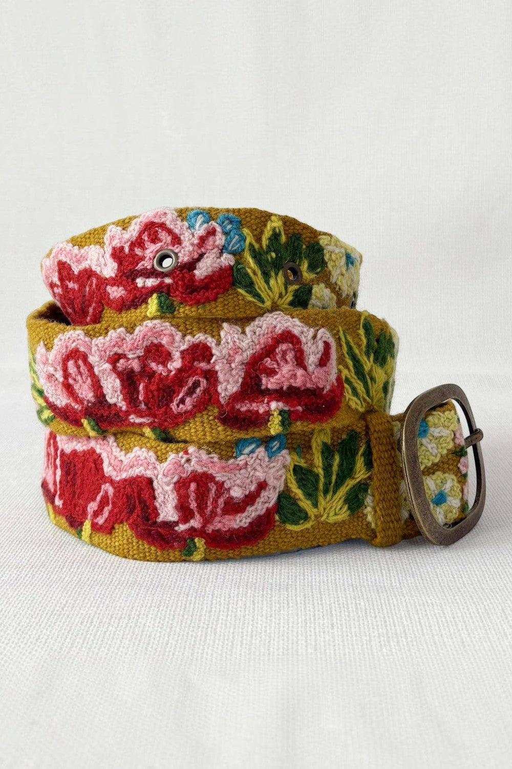 ELSHAM BOUTIQUE Giverny wool belt featuring vibrant floral embroidery in red and green with a metal buckle.