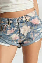 ELSHAM BOUTIQUE low waist denim shorts in Cobaine Blue with a pink and white floral print and rolled hem detail.