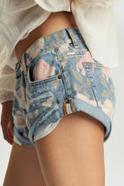 ELSHAM BOUTIQUE low waist denim shorts in Cobaine Blue with a floral print, featuring a rolled hem and patch pockets.