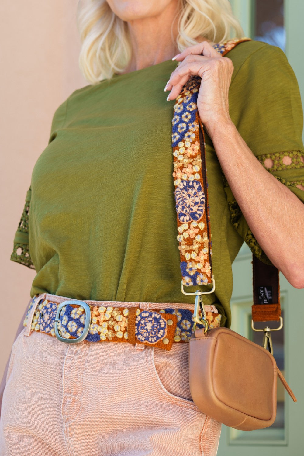 ELSHAM BOUTIQUE blue and orange floral embroidered wool belt worn with a matching bag strap and olive green top