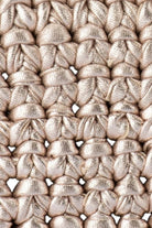 Close-up of ELSHAM BOUTIQUE Taylor crochet clutch in metallic gold, showing intricate hand-crocheted texture.