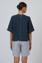 ELSHAM BOUTIQUE gunsmoke linen top with contrast stitching, short sleeves, and back keyhole button closure