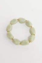 ELSHAM BOUTIQUE Havana stretch bracelet featuring pale green resin beads and small gold-tone metal accents.