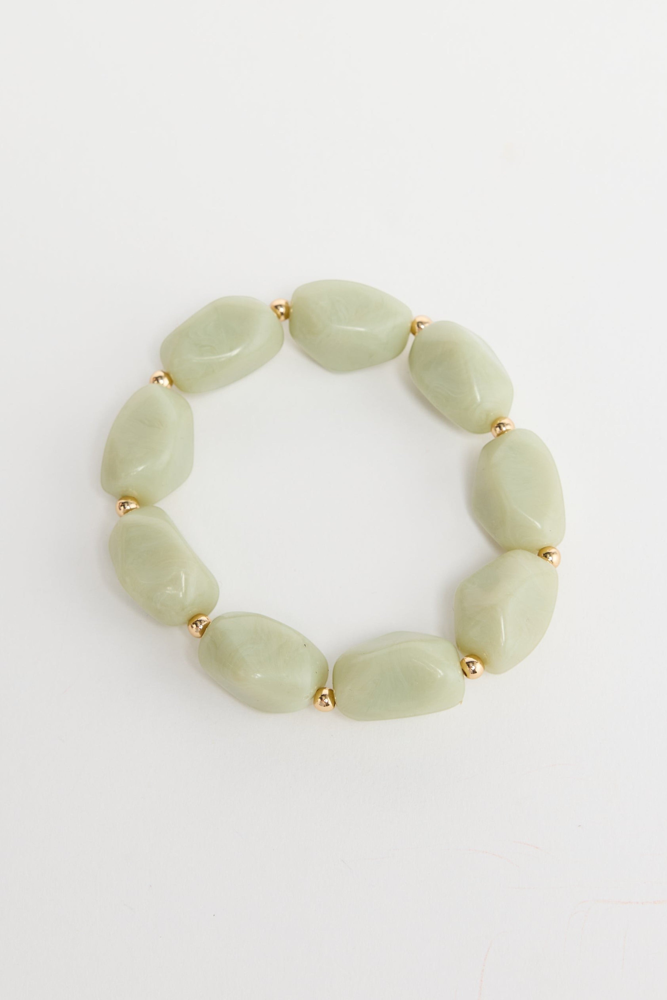 ELSHAM BOUTIQUE Havana stretch bracelet featuring pale green resin beads and small gold-tone metal accents.