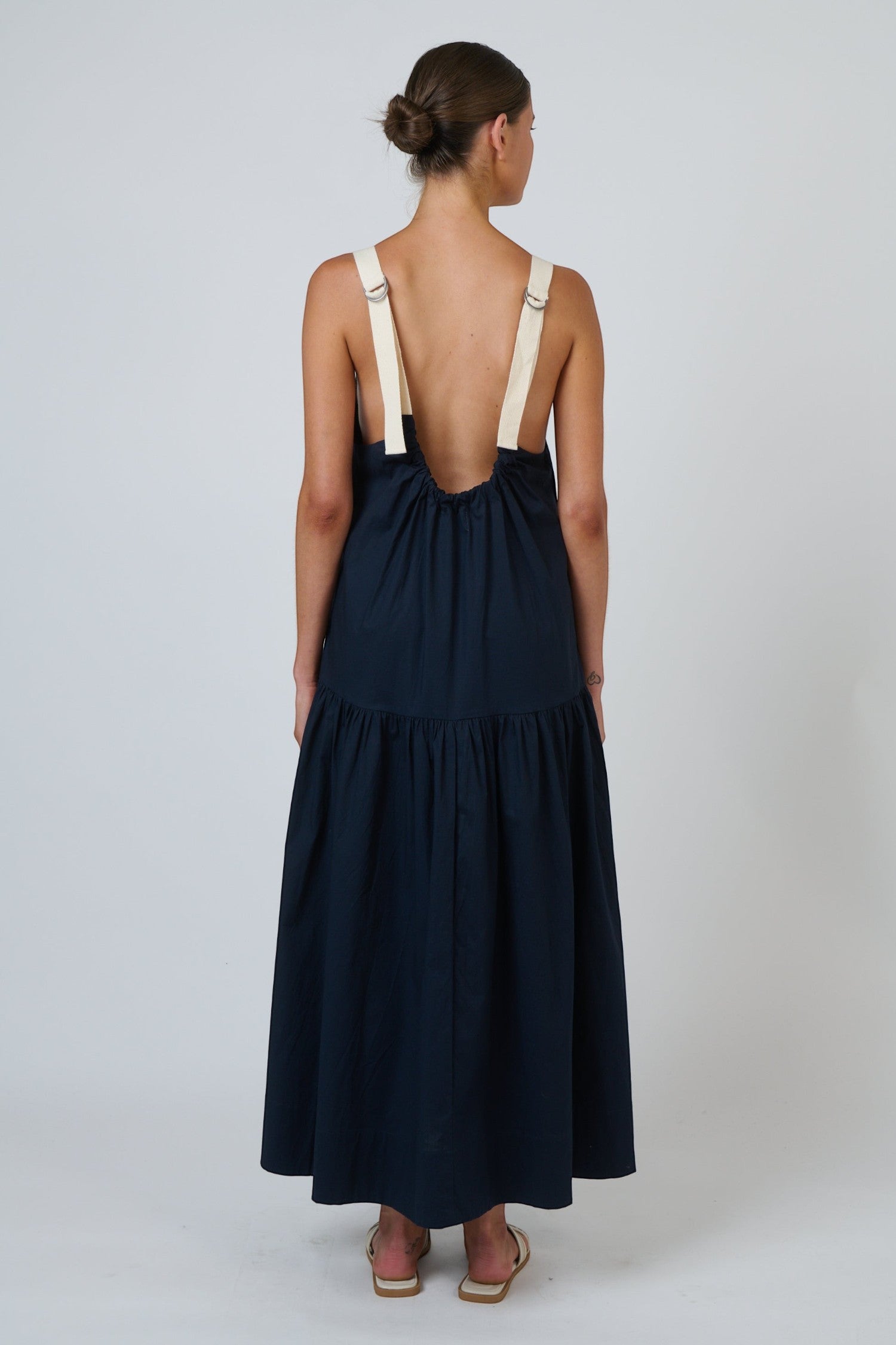 Back view of ELSHAM BOUTIQUE ink poplin maxi dress with contrast buckle straps and tiered skirt