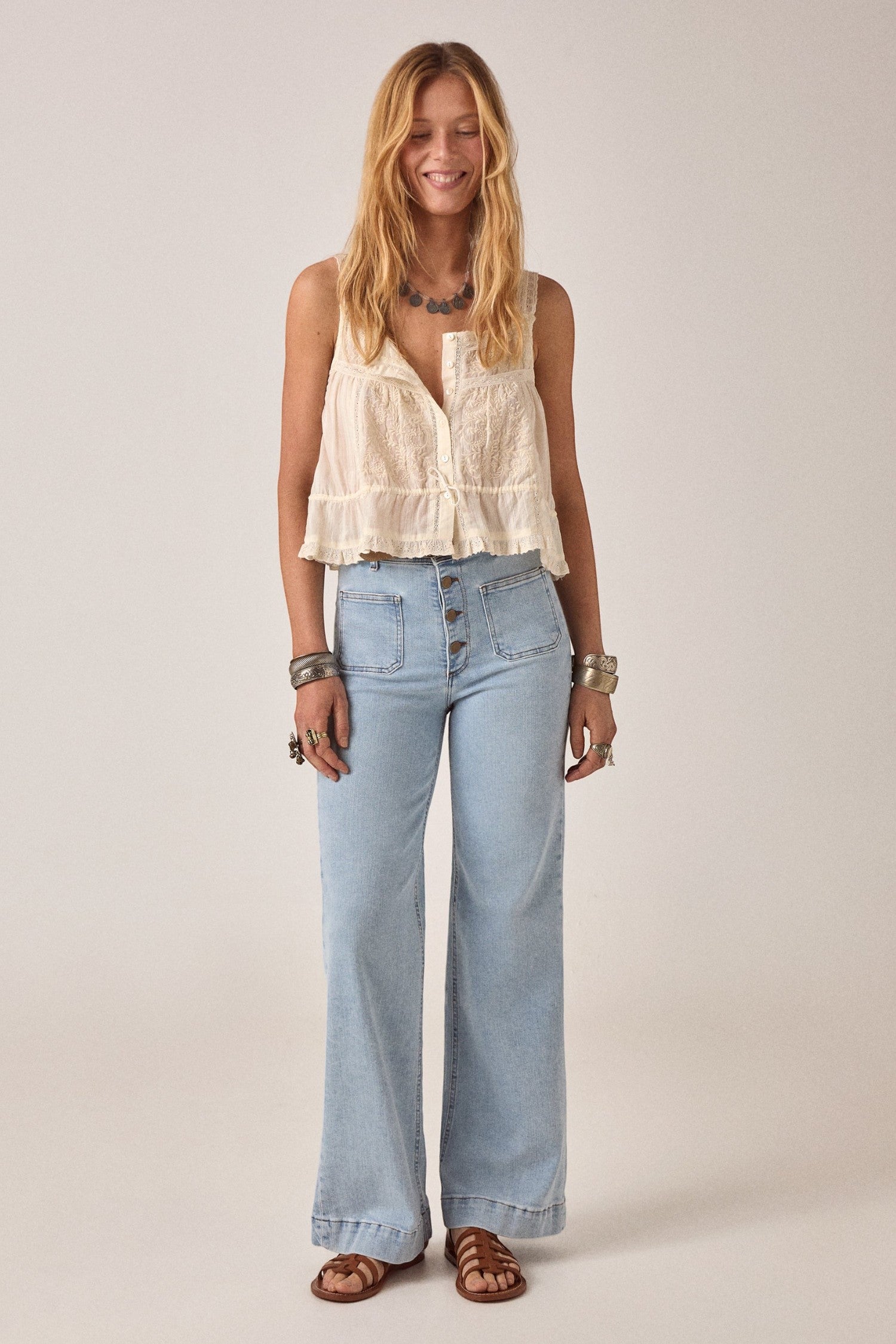 ELSHAM BOUTIQUE ivory cotton Constanza top with lace panel, thin straps, and drawstring waist worn with light jeans.