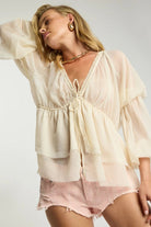ELSHAM BOUTIQUE ivory sheer chiffon blouse with deep V-neck, lace trim, and voluminous peasant sleeves on a model.