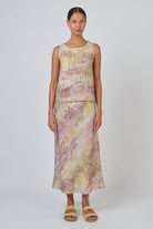 ELSHAM BOUTIQUE Jardin sleeveless linen top with high-low hem and matching skirt in a pink and yellow abstract print.