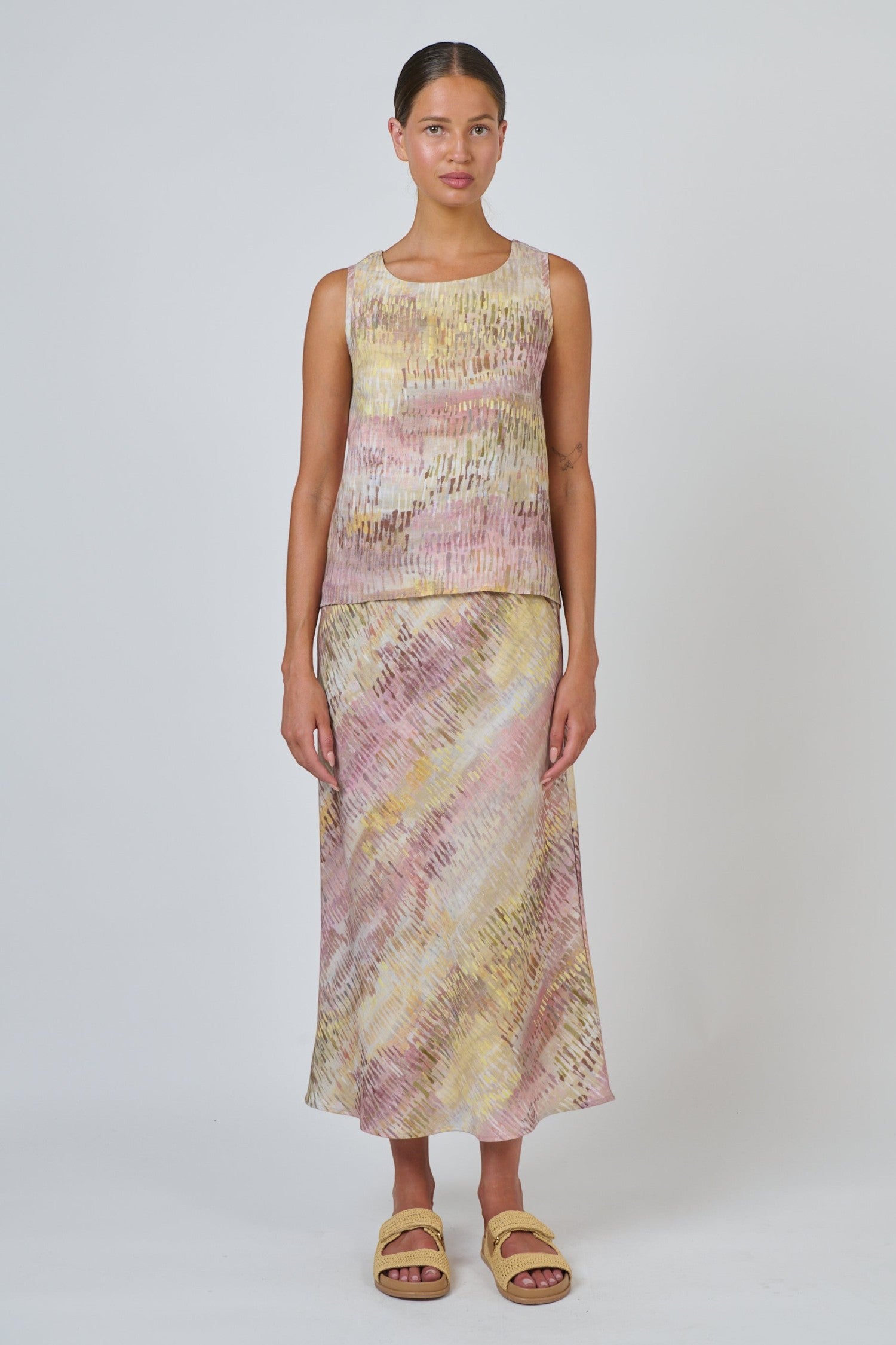 ELSHAM BOUTIQUE Jardin sleeveless linen top with high-low hem and matching skirt in a pink and yellow abstract print.