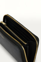 ELSHAM BOUTIQUE Maxi Wallet in black grained calf leather with brass zip closure and multiple internal compartments.