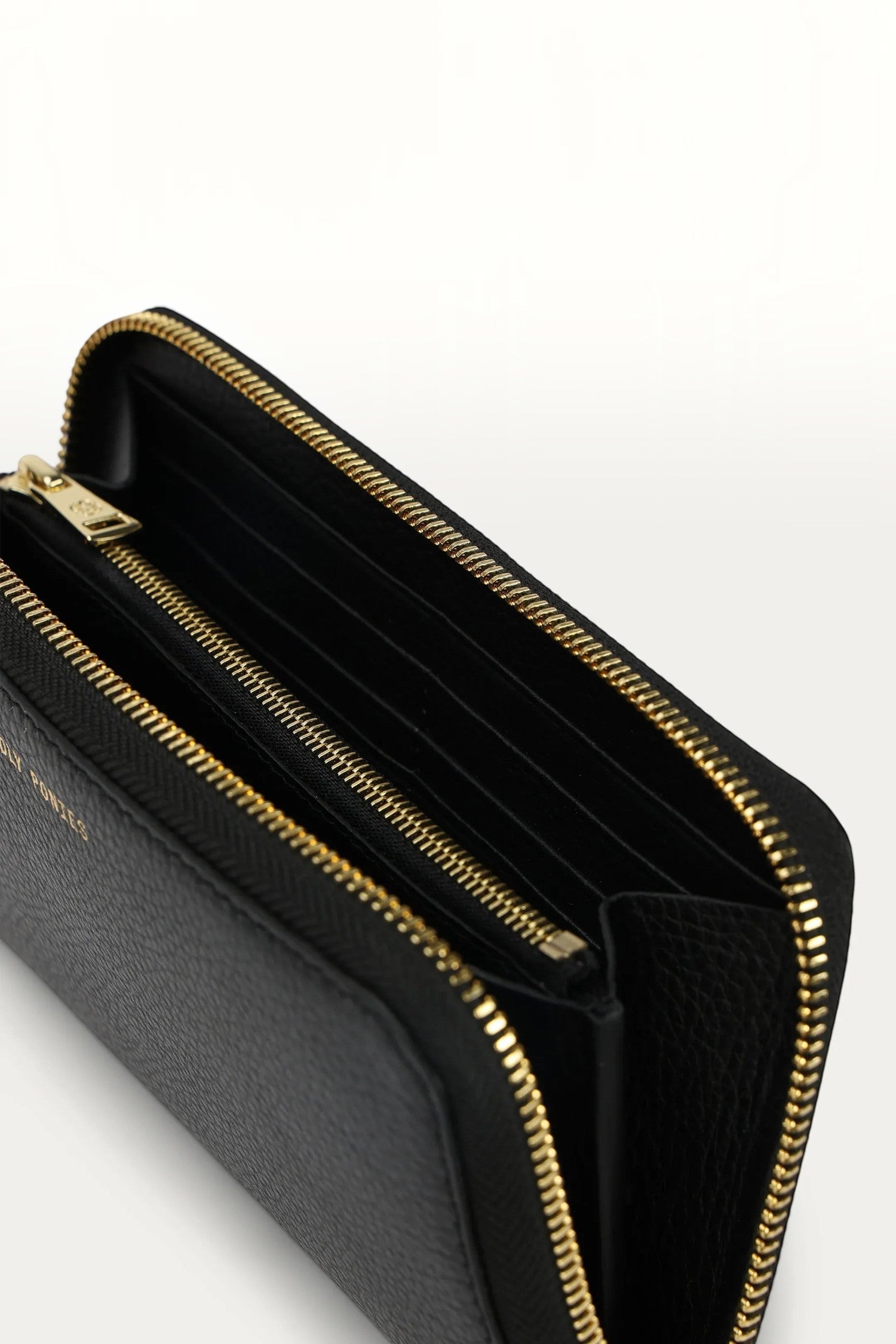 ELSHAM BOUTIQUE Maxi Wallet in black grained calf leather with brass zip closure and multiple internal compartments.