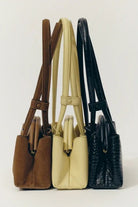 ELSHAM BOUTIQUE Mini Vault Totes in brown suede, cream leather, and black textured leather with fixed top handles.