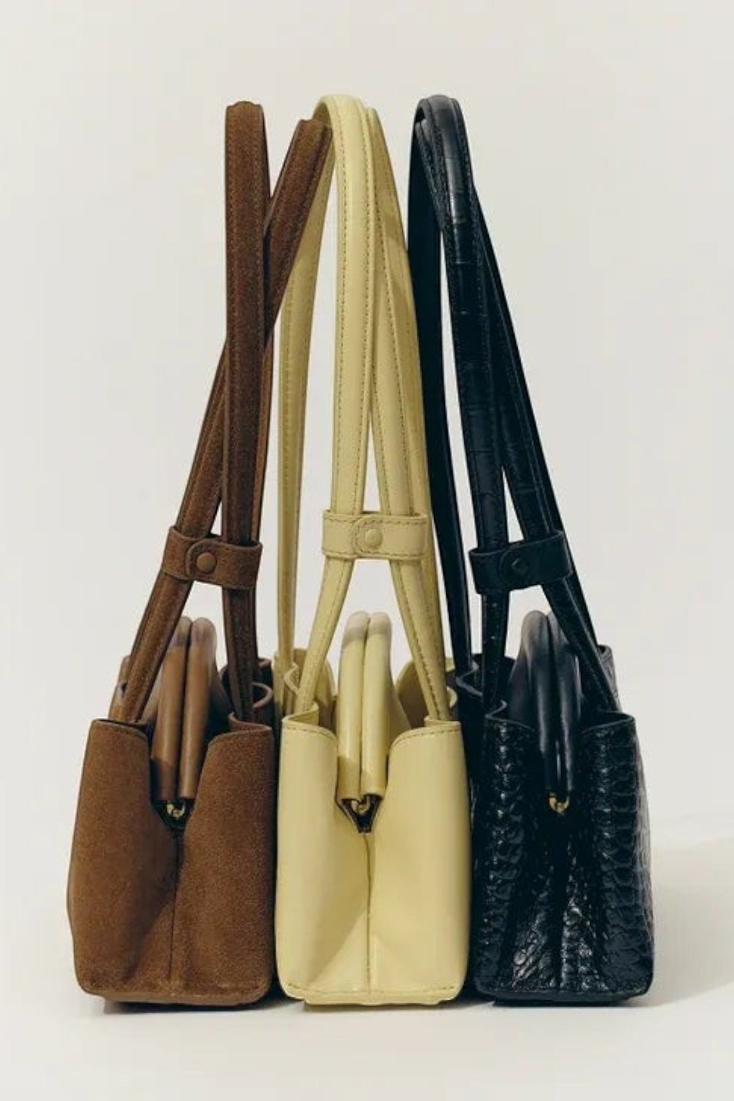 ELSHAM BOUTIQUE Mini Vault Totes in brown suede, cream leather, and black textured leather with fixed top handles.