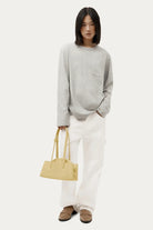 ELSHAM BOUTIQUE Mini Vault Tote in lemonade yellow calf nappa leather held by a model in a casual outfit