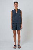 ELSHAM BOUTIQUE GA477 navy pinstripe linen shorts with a drawstring waistband worn by a model in a relaxed fit.