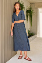 ELSHAM BOUTIQUE navy pinstripe linen A-line midi dress with V-neck and elbow-length sleeves worn by a model