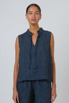 ELSHAM BOUTIQUE navy pinstripe linen sleeveless top with a V-neckline and adjustable neck tie on a model
