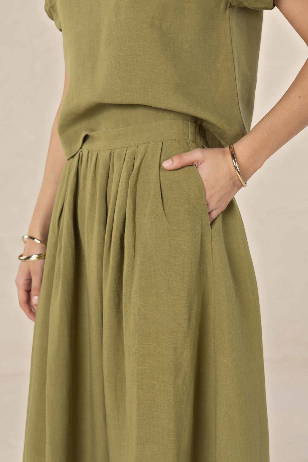 ELSHAM BOUTIQUE olive midi skirt in a soft linen-tencel blend with an A-line silhouette and functional side pockets.